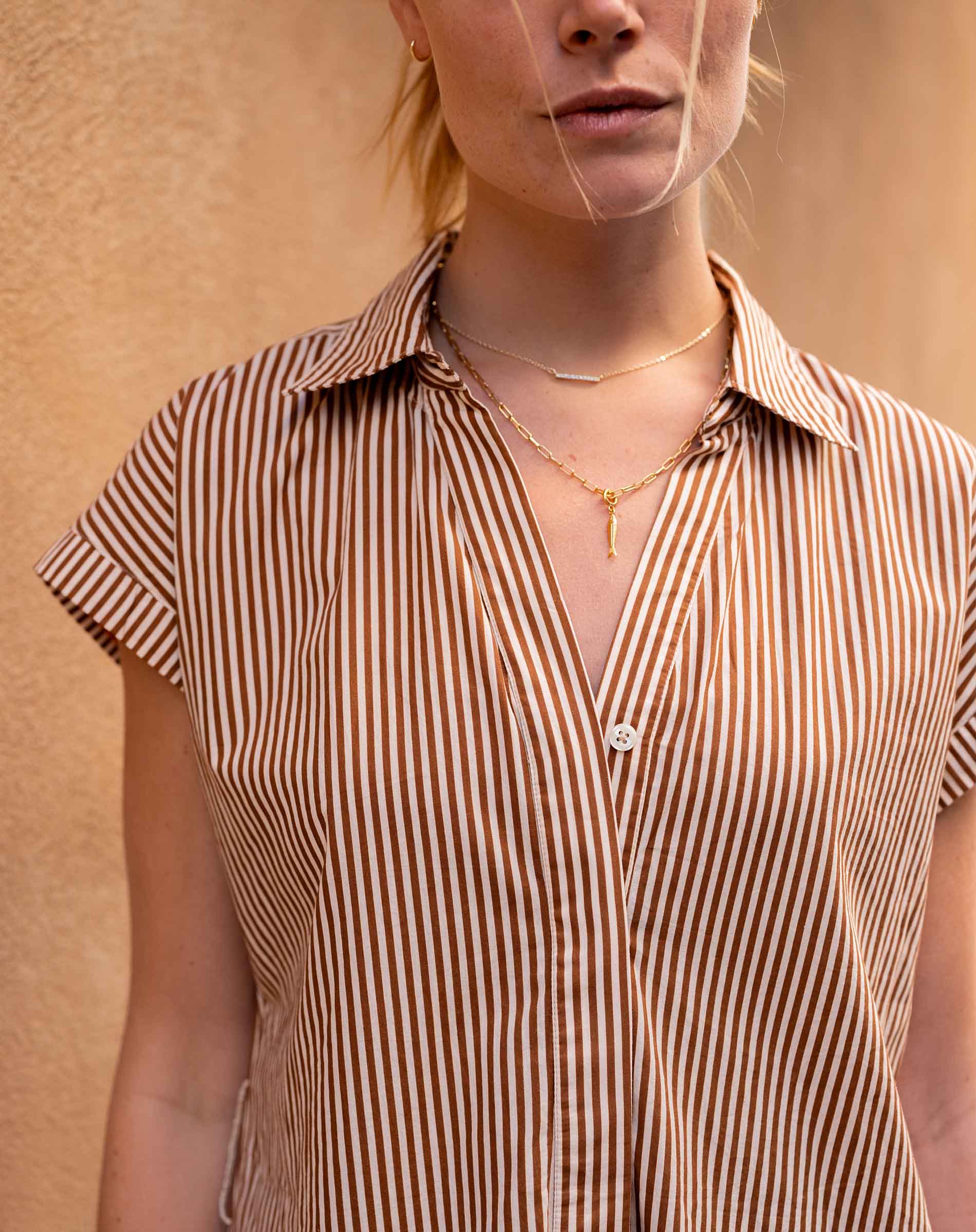 Woman wearing a striped shirt with a neutral background