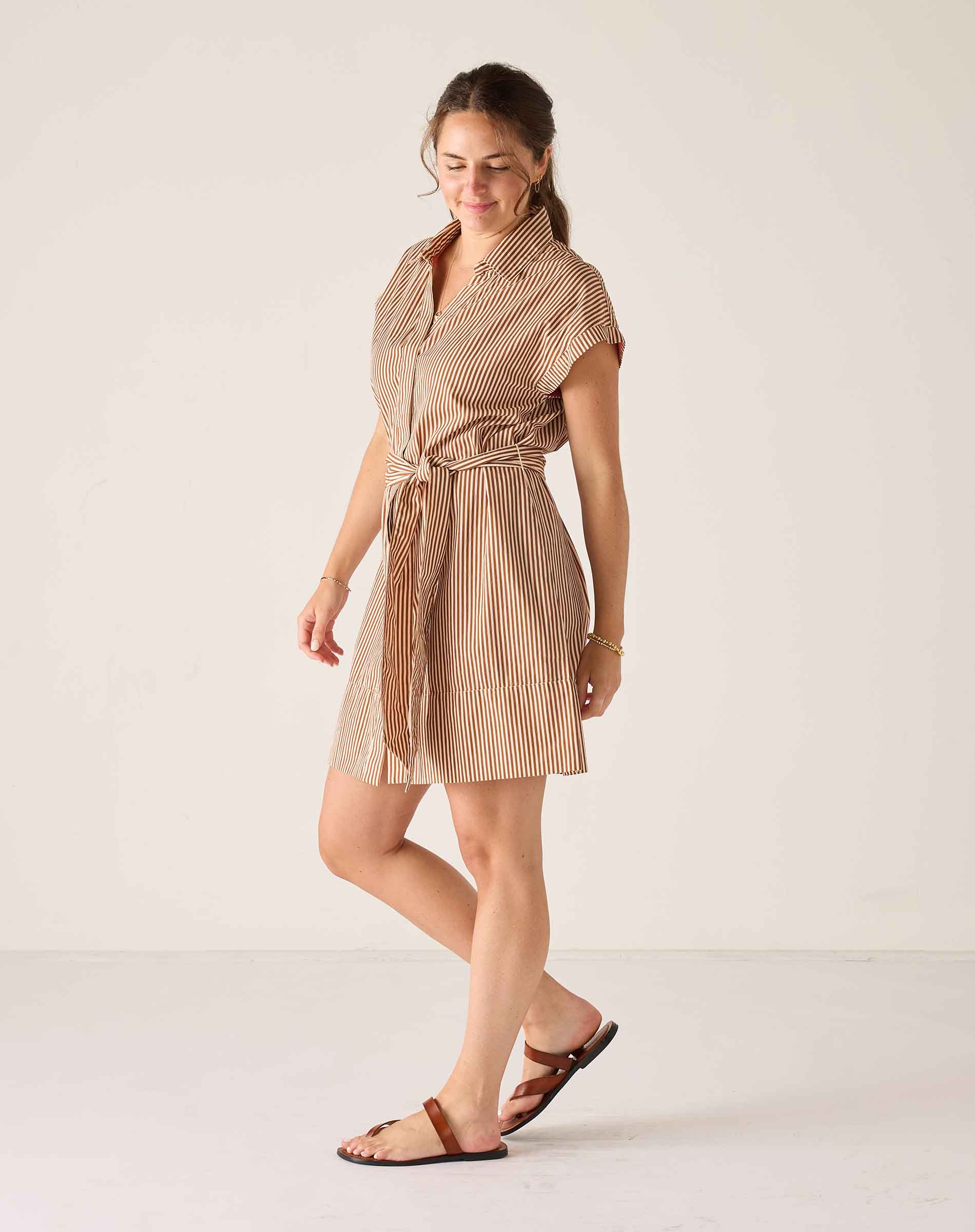 Woman wearing a striped dress on a white background