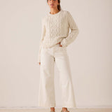 MERSEA women's travel-friendly cream cable-knit sweater and wide-leg white linen pants set.