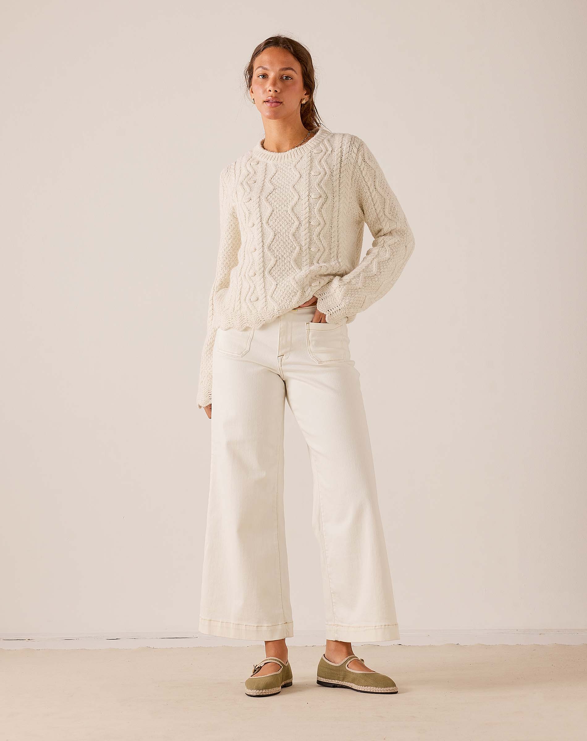 MERSEA women's travel-friendly cream cable-knit sweater and wide-leg white linen pants set.