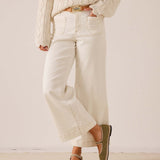 White sailor cropped wide-leg pants with front patch pockets and large cuffs.