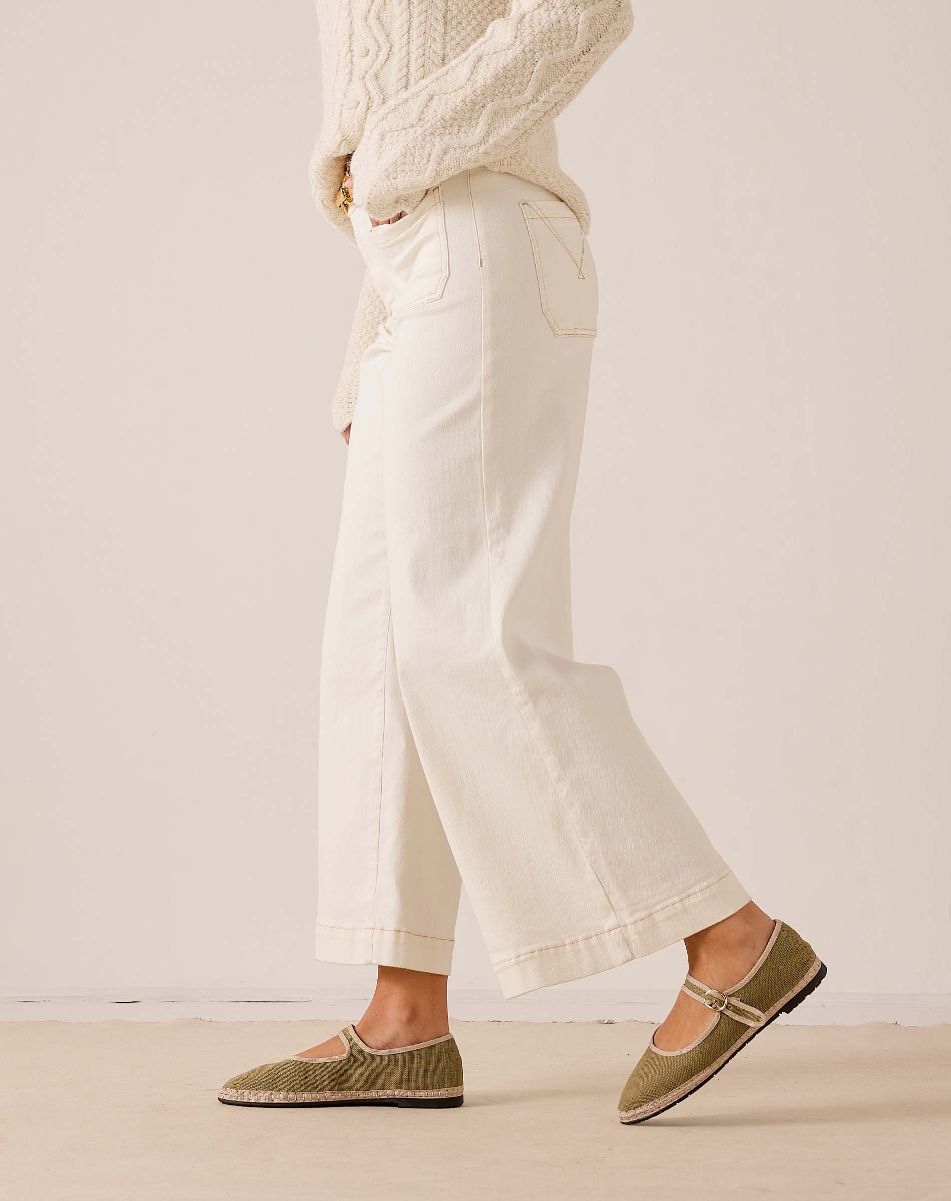 White cropped wide-leg pants in a textured woven fabric with a decorative stitched pocket.