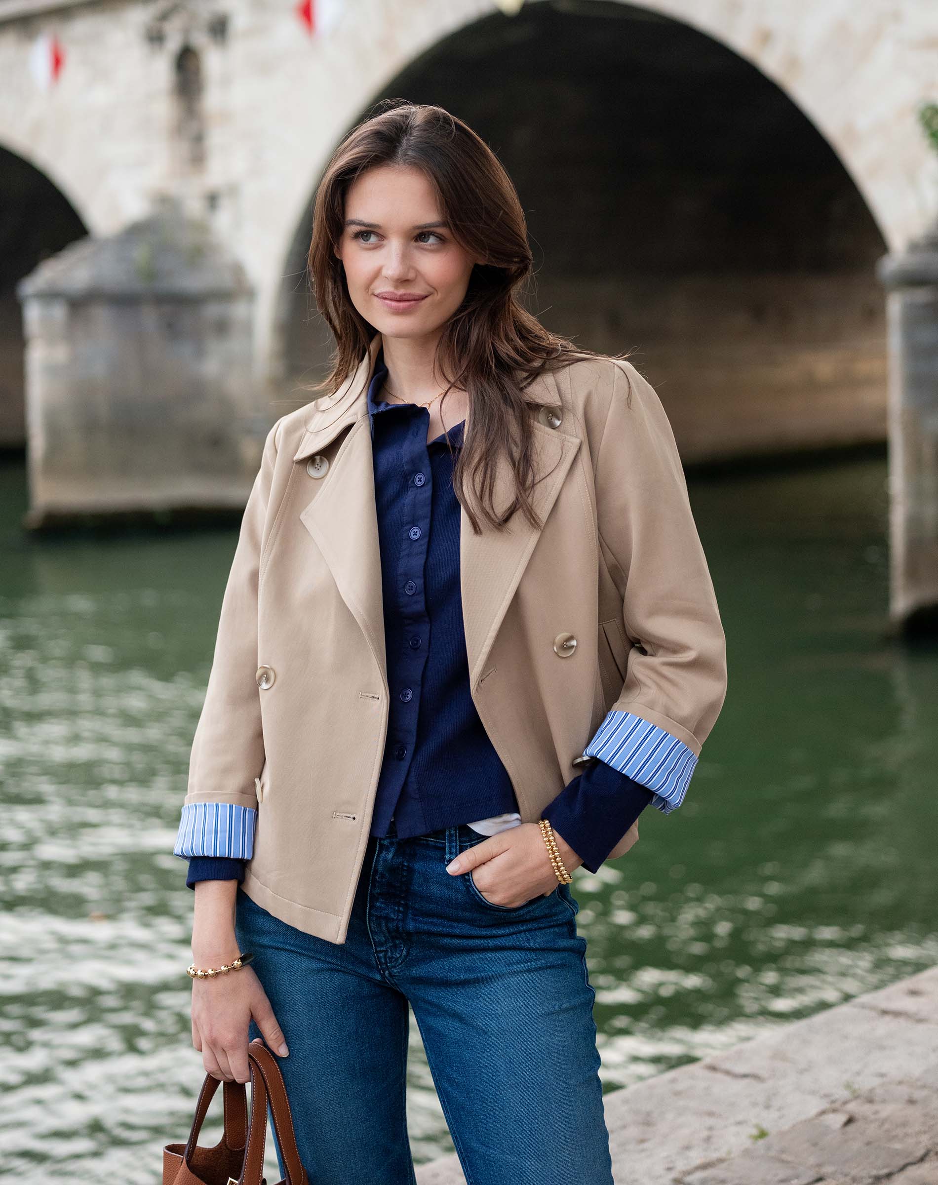 Classic khaki sailor peacoat with a button front and unique blue striped trim on the cuffs.