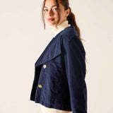 Navy blue double-breasted peacoat in a soft corduroy fabric with large buttons.