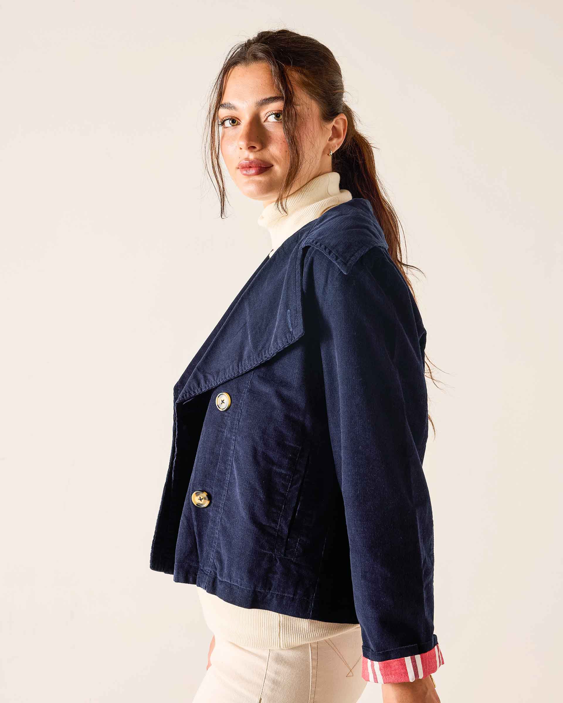 Navy blue double-breasted peacoat in a soft corduroy fabric with large buttons.