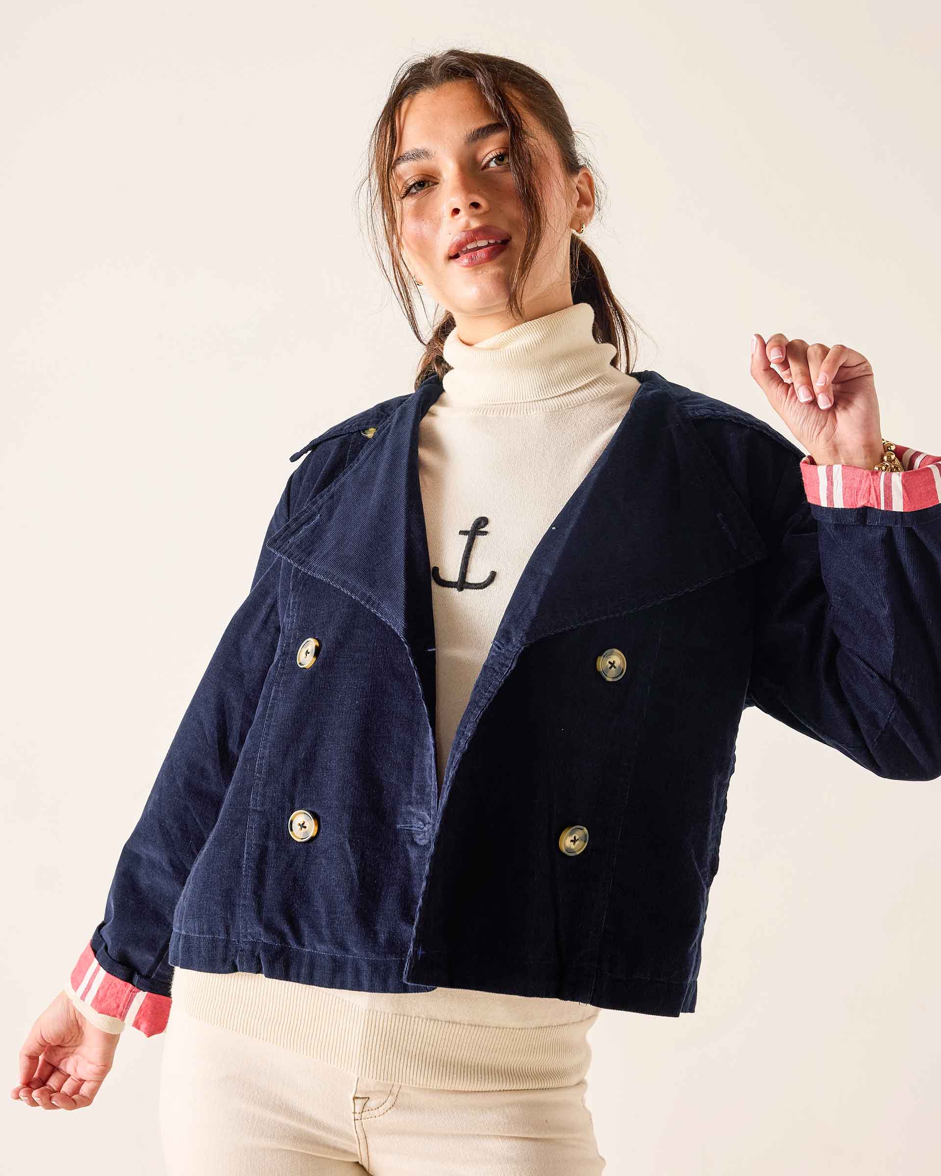 Navy blue double-breasted corduroy peacoat with gold buttons and striped cuffs.