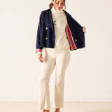 Navy blue corduroy sailor peacoat with gold button details and striped cuff lining.