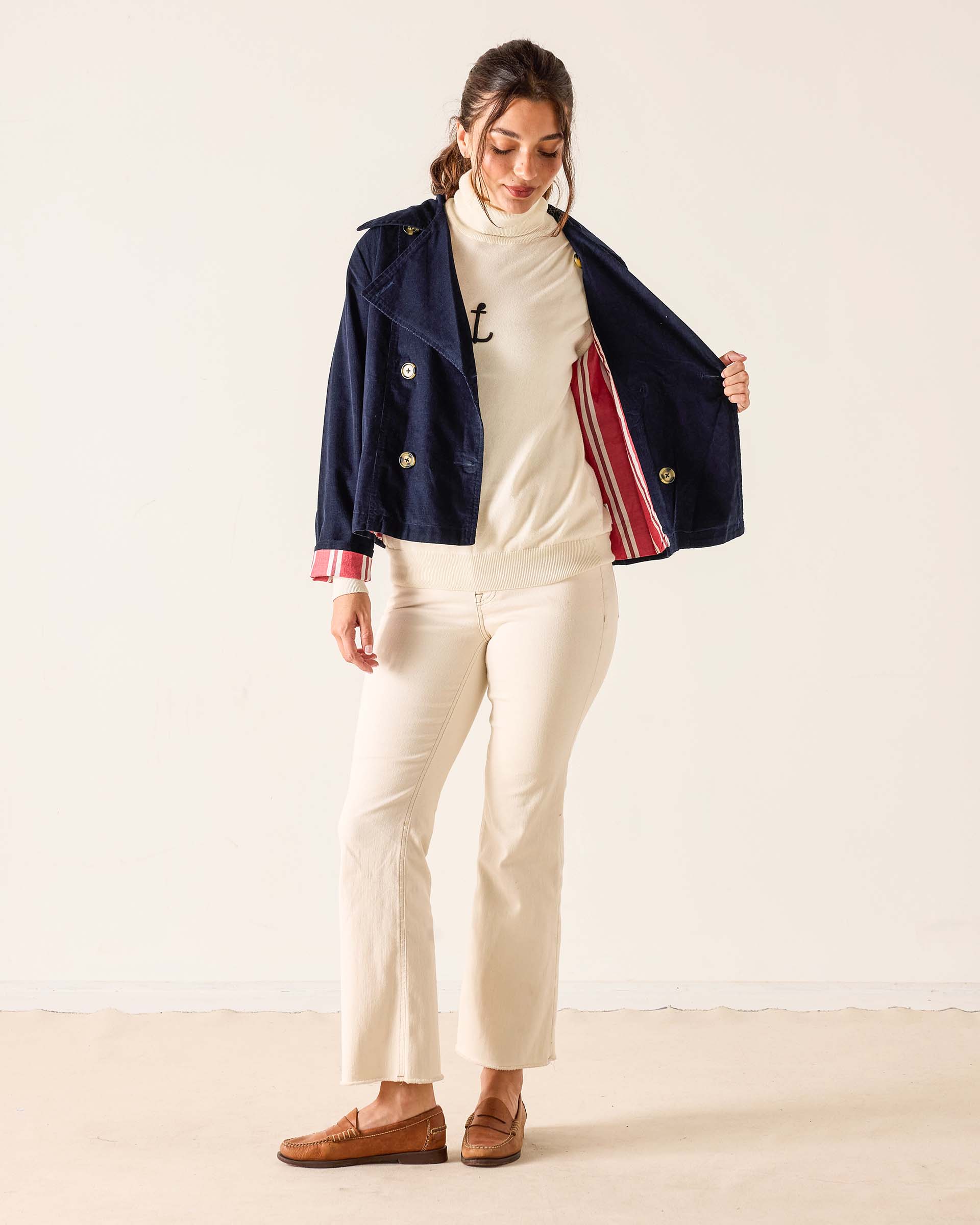 Navy blue corduroy sailor peacoat with gold button details and striped cuff lining.