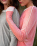 Close up of female shoulder wearing pink hand-dyed cashmere sweater