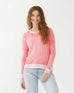 female wearing pink hand-dyed cashmere sweater standing on a white background