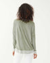 female wearing sea moss green hand-dyed cashmere sweater backwards on a white background