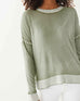 close up of female wearing sea moss green hand-dyed cashmere sweater on a white background