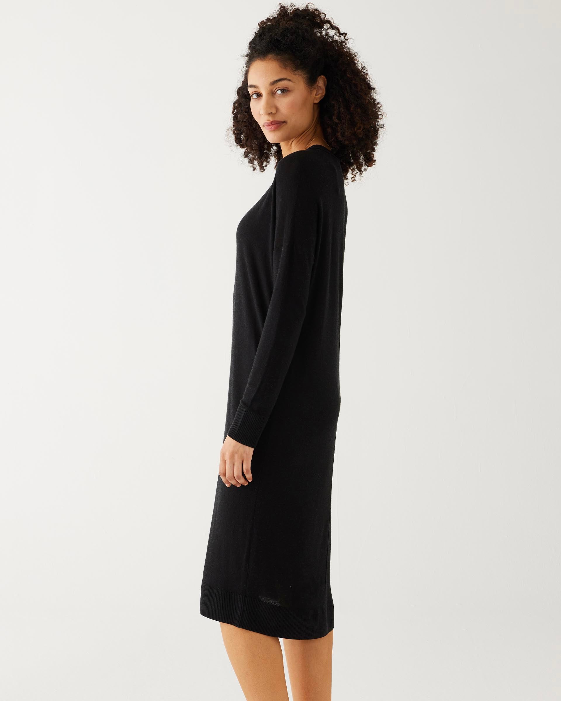 profile of woman showcasing mersea black long sleeve v neck saltwash sweater dress