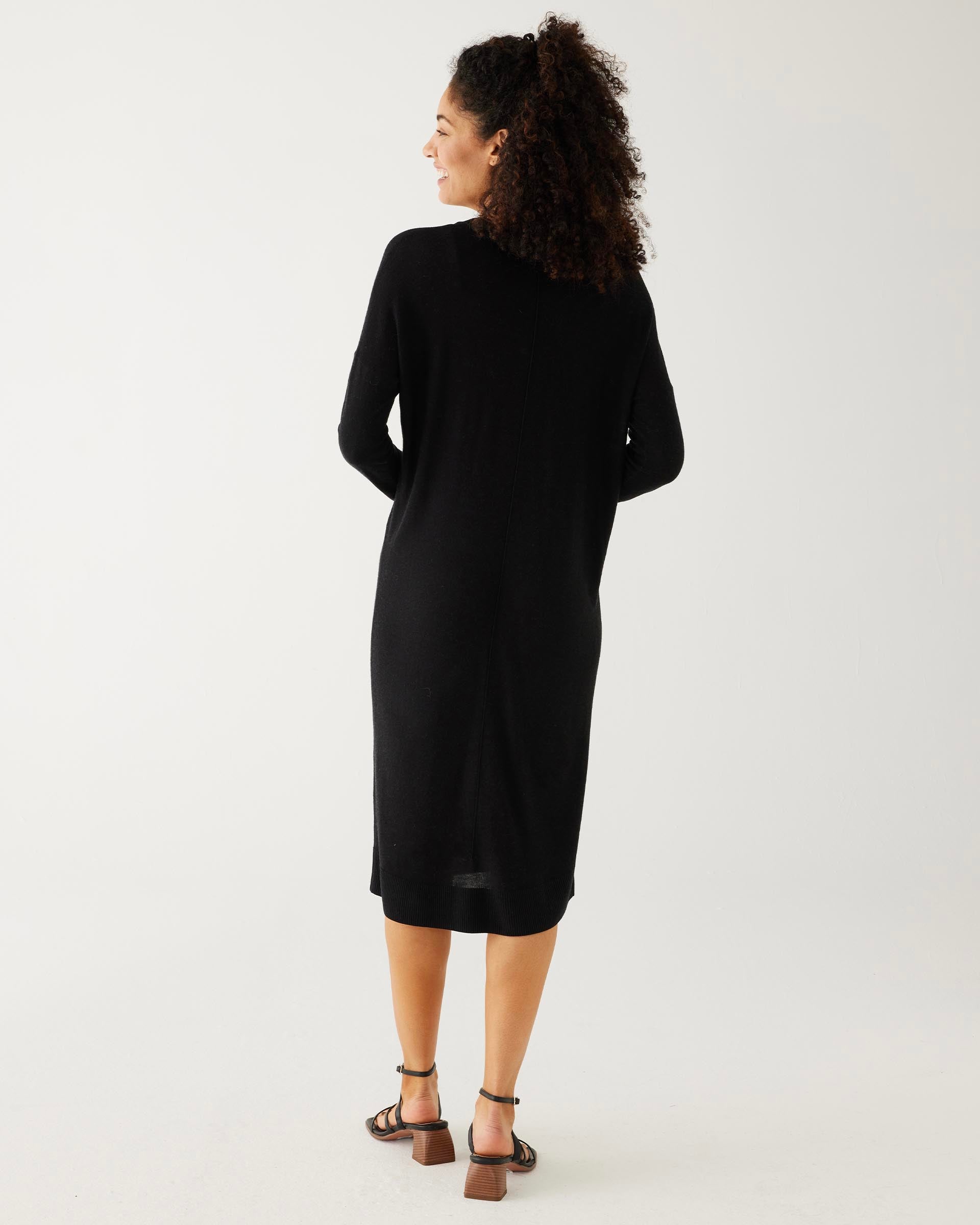 rearview of woman showcasing mersea black long sleeve v neck saltwash sweater dress