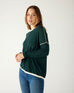 profile of woman wearing mersea saltwash sweater in forest green