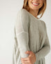 closeup of sleeve on woman wearing mersea saltwash sweater in grey
