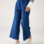 closeup of pants on woman wearing blue and white striped shirt with mersea sammie chambray pants on a white background