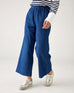 closeup of pants on woman wearing blue and white striped shirt with mersea sammie chambray pants on a white background