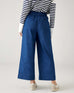 rear view of woman wearing blue and white striped shirt with mersea sammie chambray pants on a white background