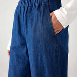 closeup of waste on woman wearing blue and white striped shirt with mersea sammie chambray pants on a white background