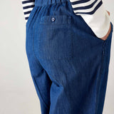 closeup of rear on woman wearing blue and white striped shirt with mersea sammie chambray pants on a white background