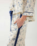 closeup of hand in pocket of mersea satin sailor jane win lucky charms pajama set against white background