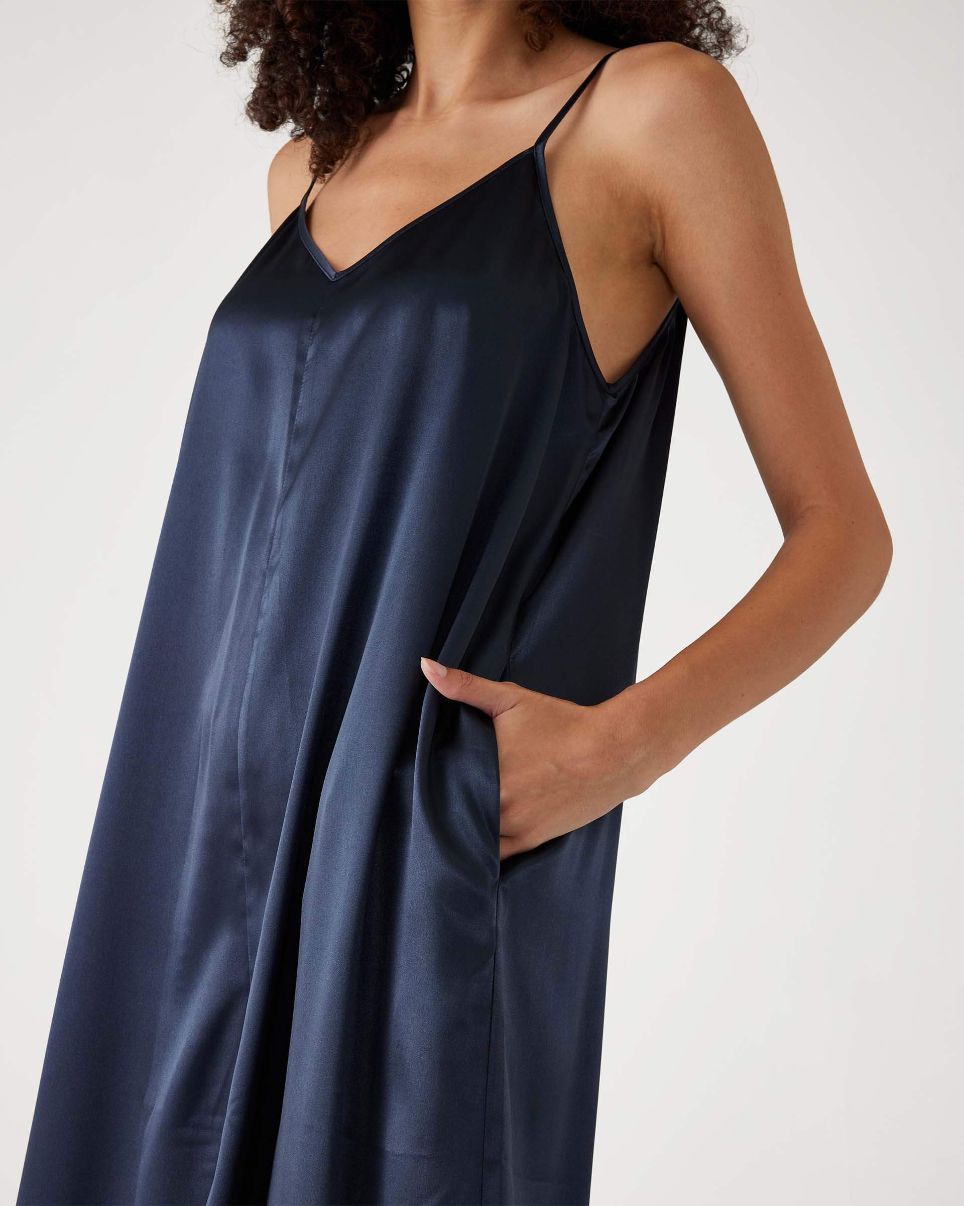 closeup of upper half of Mersea garnet satin jumpsuit on female against white background