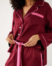 closeup of waste of Mersea garnet satin sailor pajama set on female against white background