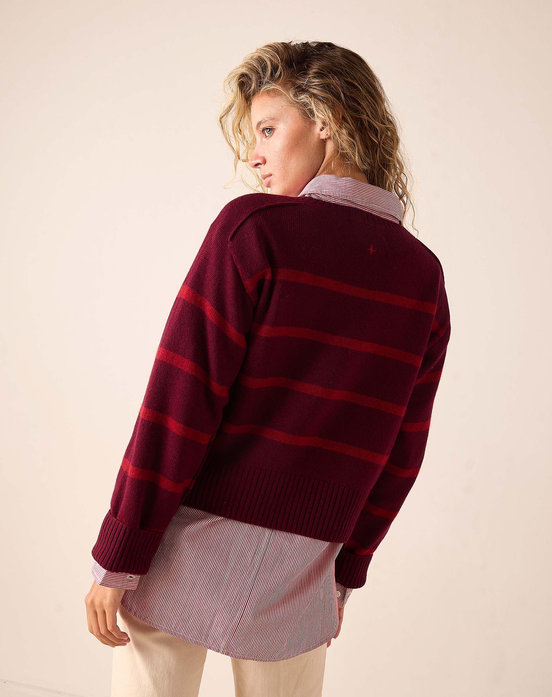 Back view of women's travel-friendly pino red striped cashmere sweater