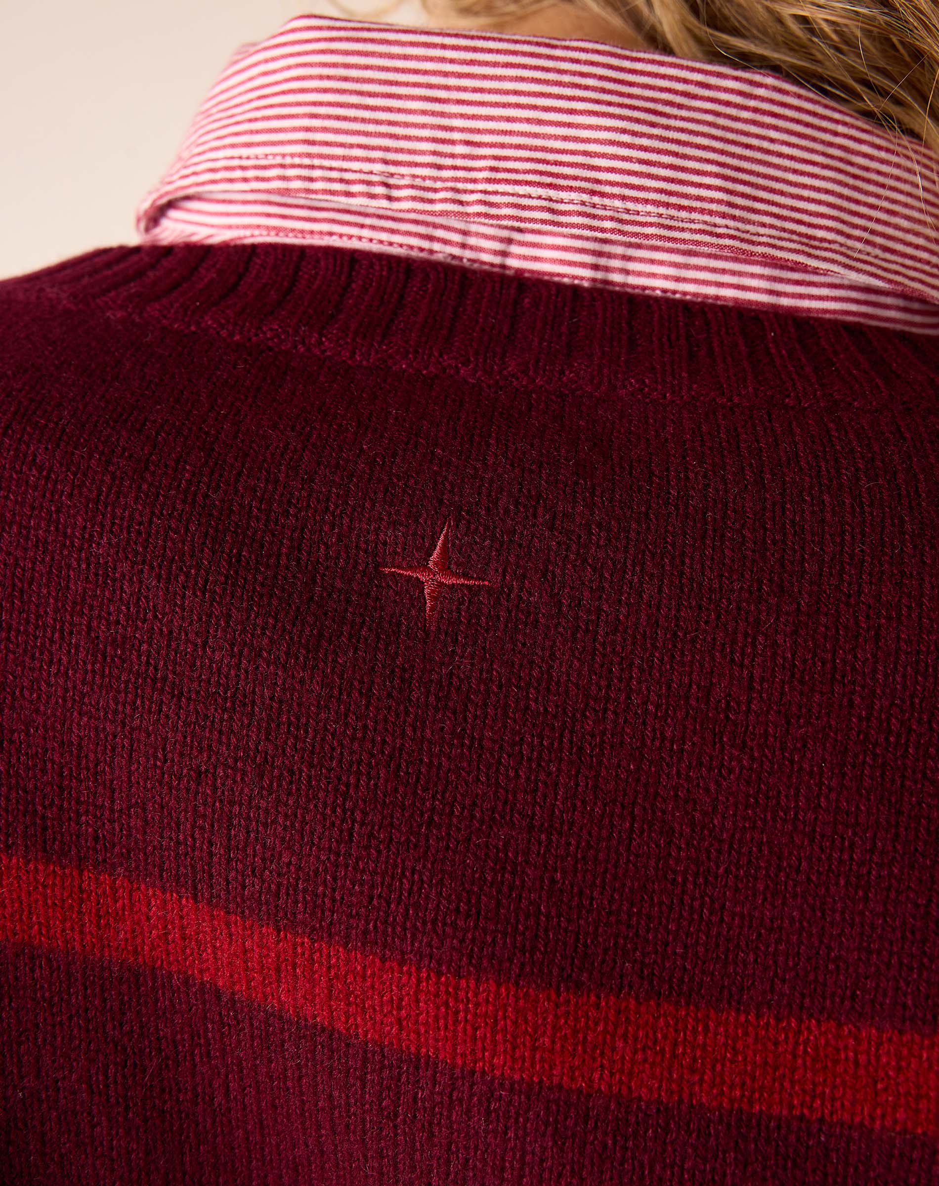 Pino red knit cashmere sweater with a horizontal stripe and embroidered star detail.