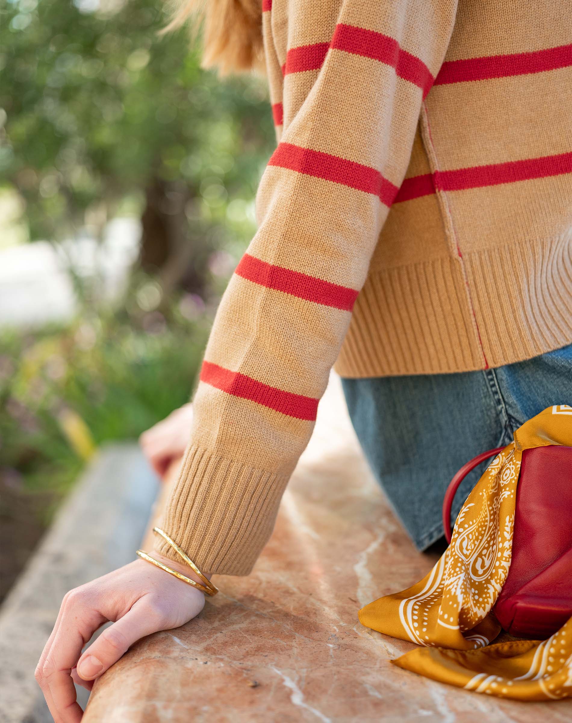 Cappuccino and crimson striped knit sweater with ribbed cuffs.