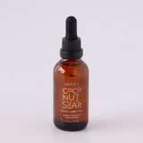 Brown glass bottle with black dropper cap on white background