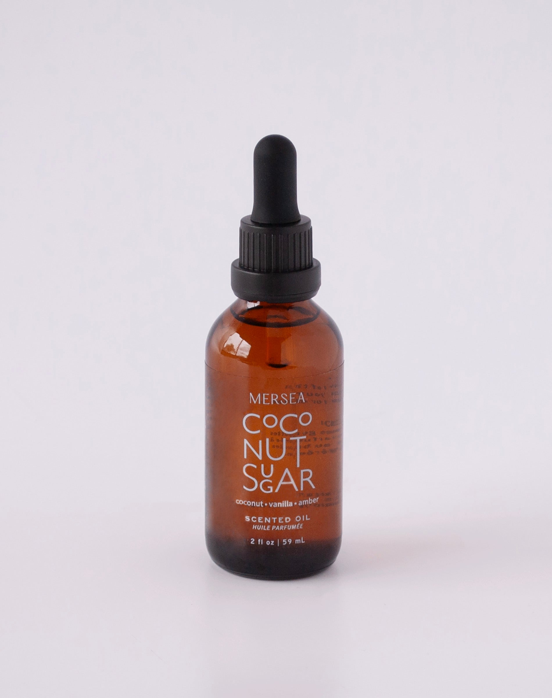Brown glass bottle with black dropper cap on white background