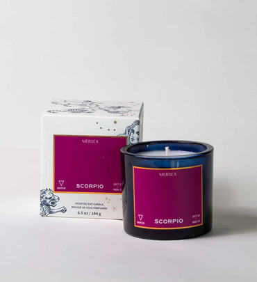 fusia scorpio candle with blue vessel and box on a white background
