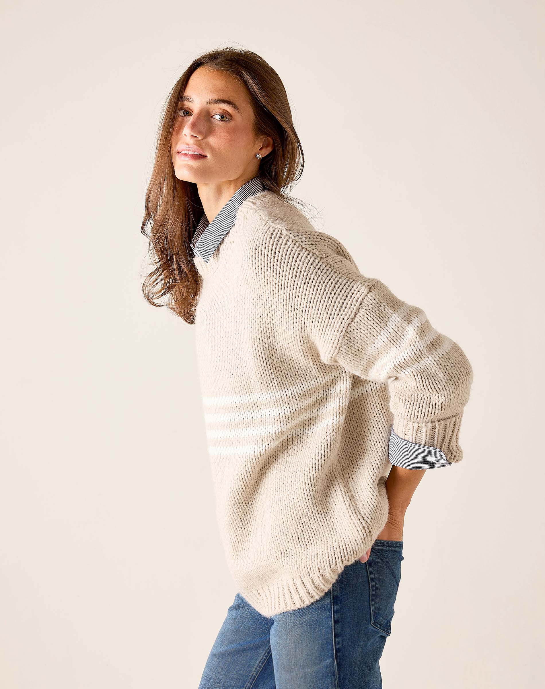 Taupe and white horizontal stripe knit sweater with a relaxed fit and wide ribbed cuffs.