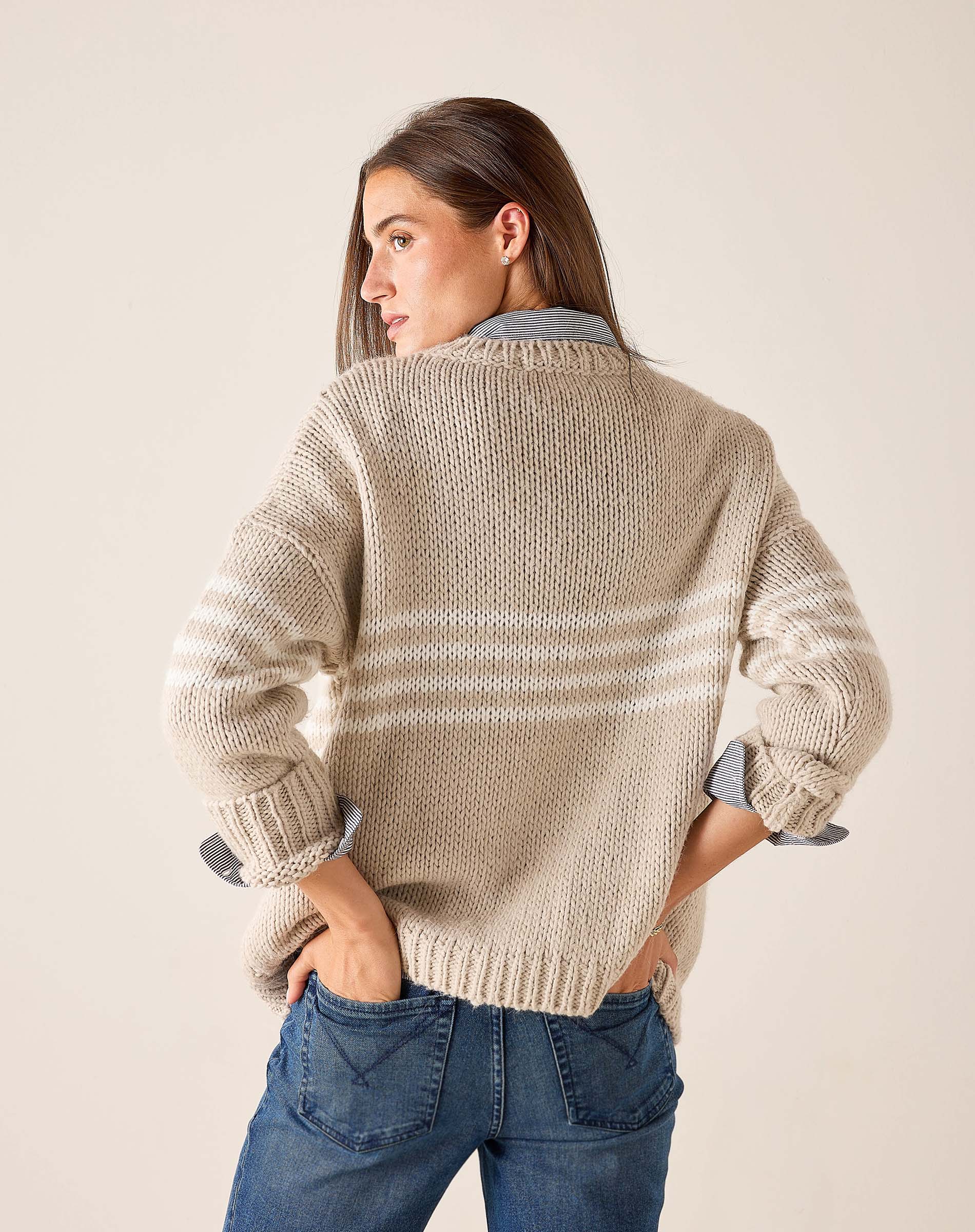 Taupe and white striped knit sweater featuring a relaxed fit with rolled sleeves.