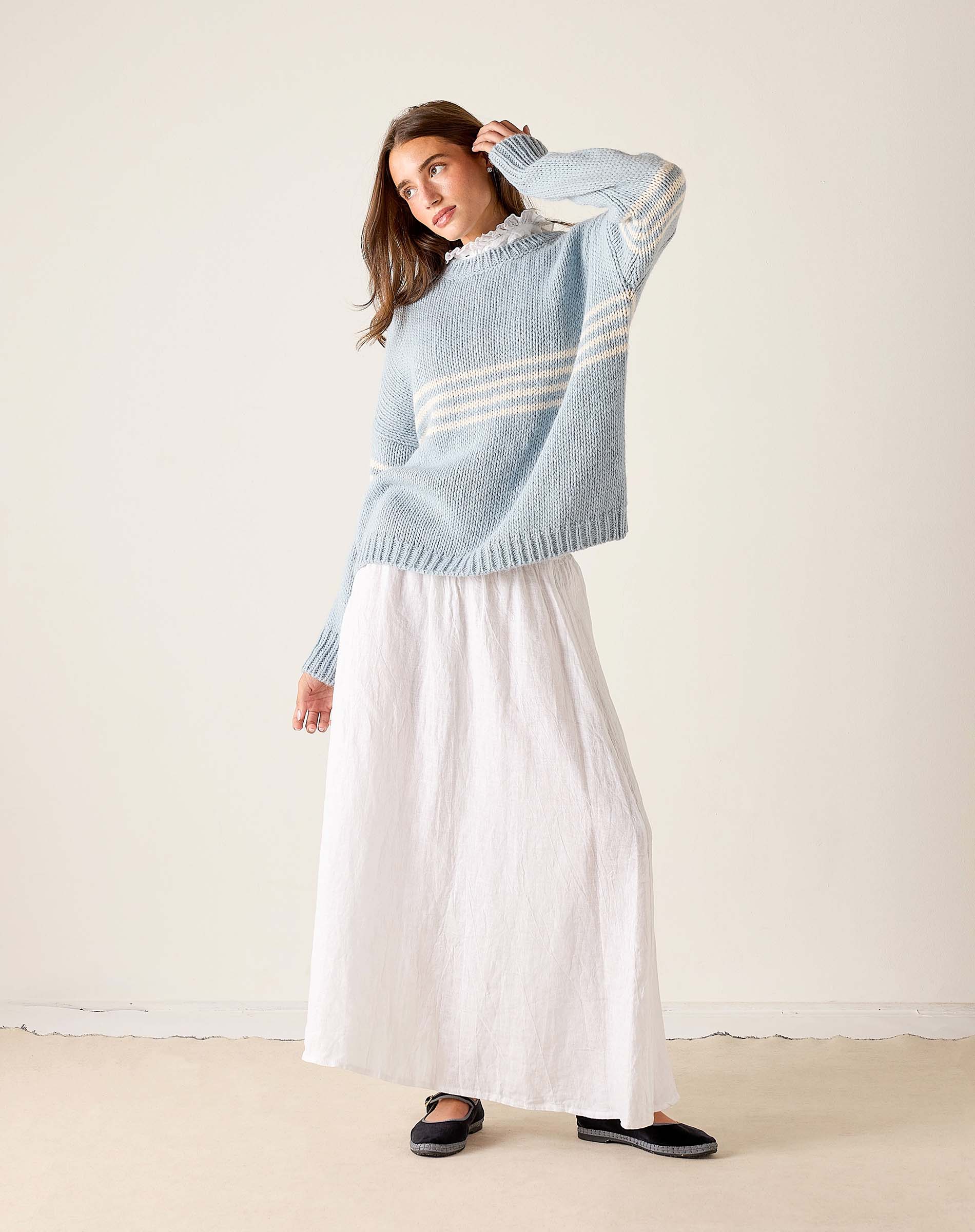 Soft sky white knit sweater with horizontal stripes and a ribbed hem.