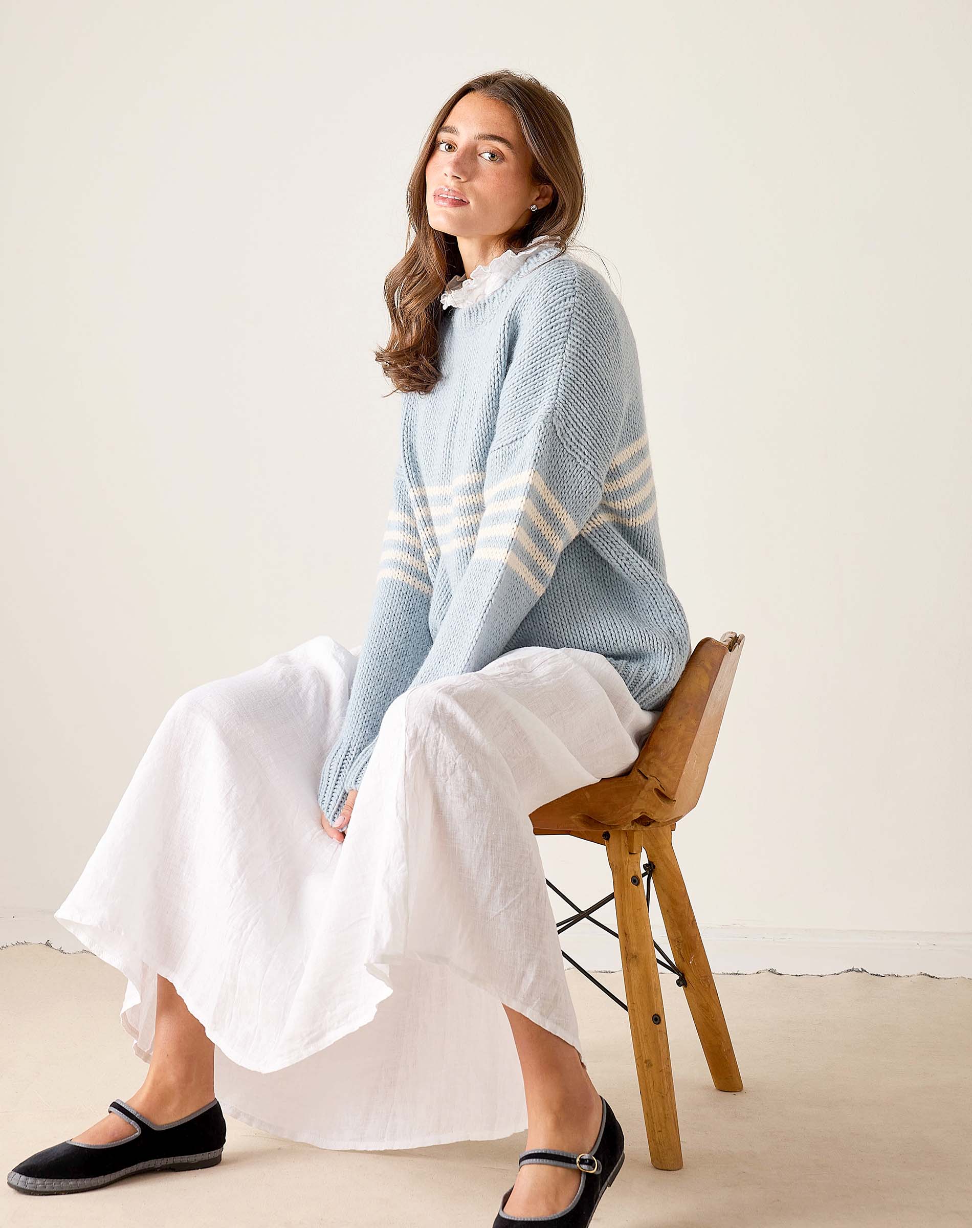Soft sky white and yellow horizontal striped knit sweater with a decorative ruffled collar.