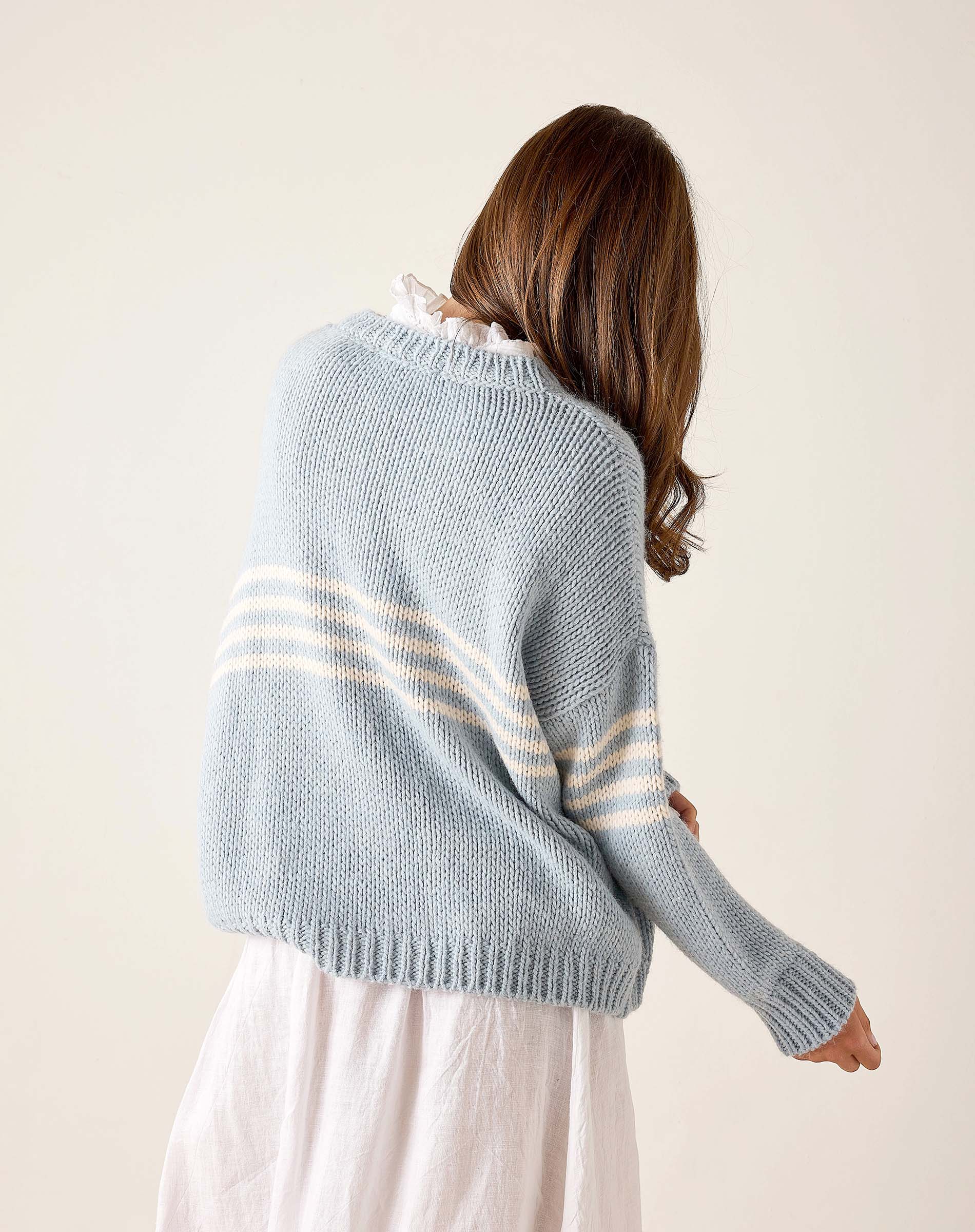 Soft sky and white striped knit sweater with ribbed cuffs