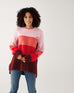 woman wearing mersea seahappy heart holiday sweater in bliss pink stripes