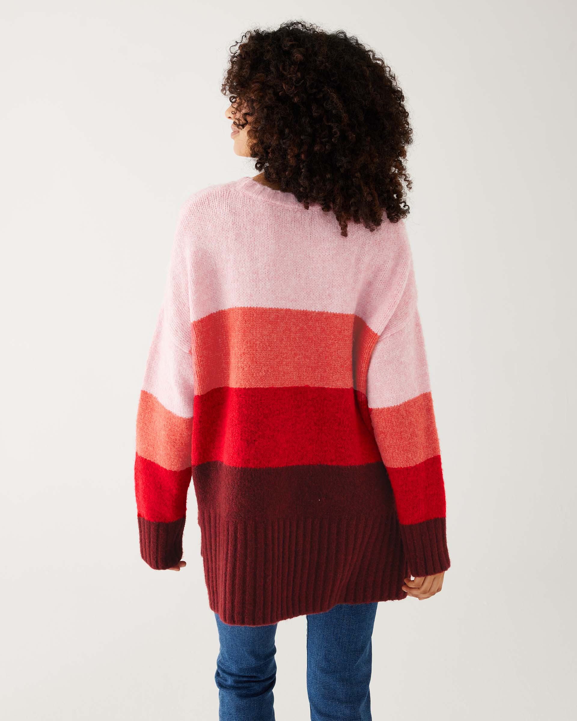 rear view of woman wearing mersea seahappy heart holiday sweater in bliss pink stripes