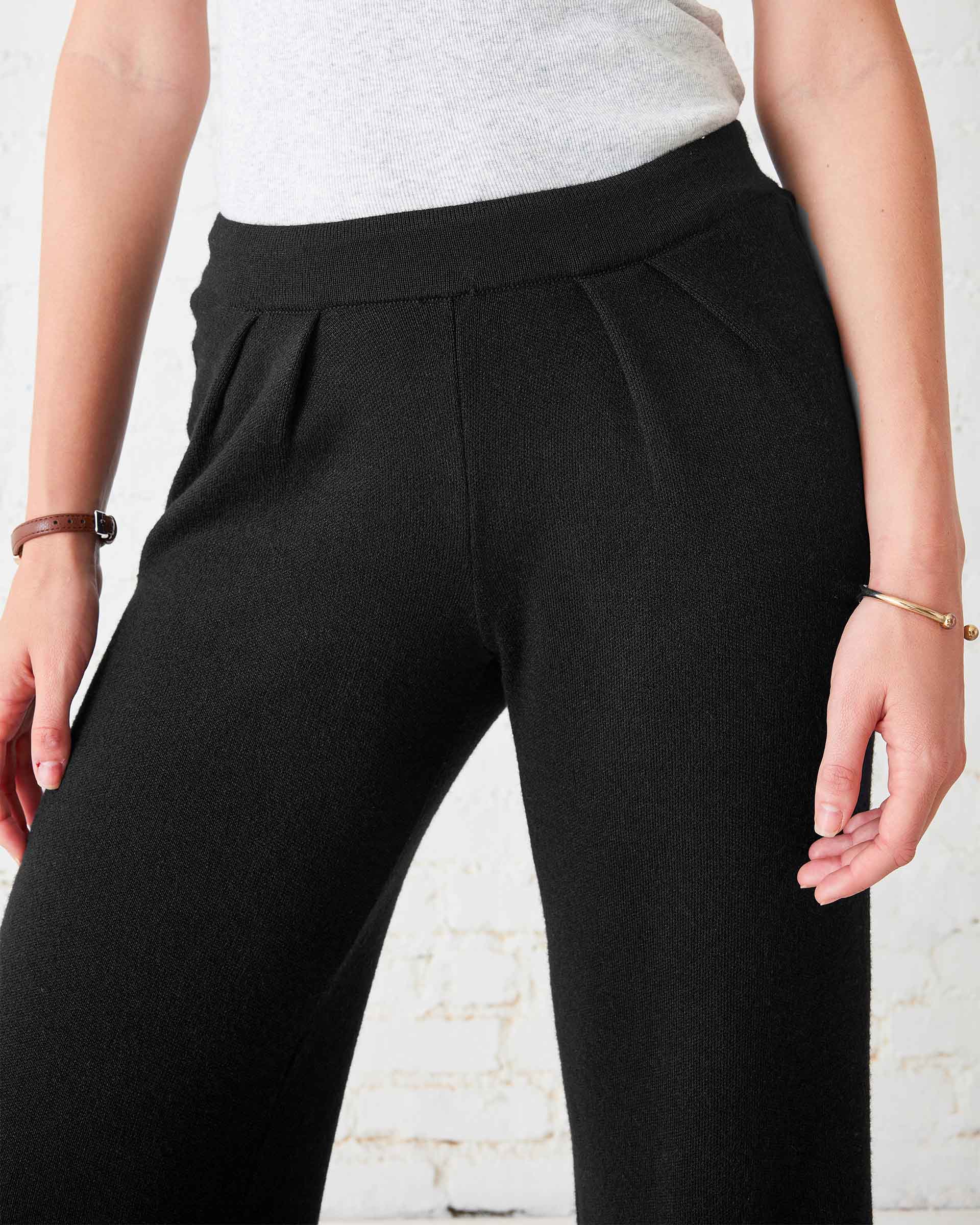 Black knit Seaport pants with a high-waisted waist and pleat details.