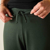 Deep emerald green knit fabric high-waisted pants with a drawstring waist.