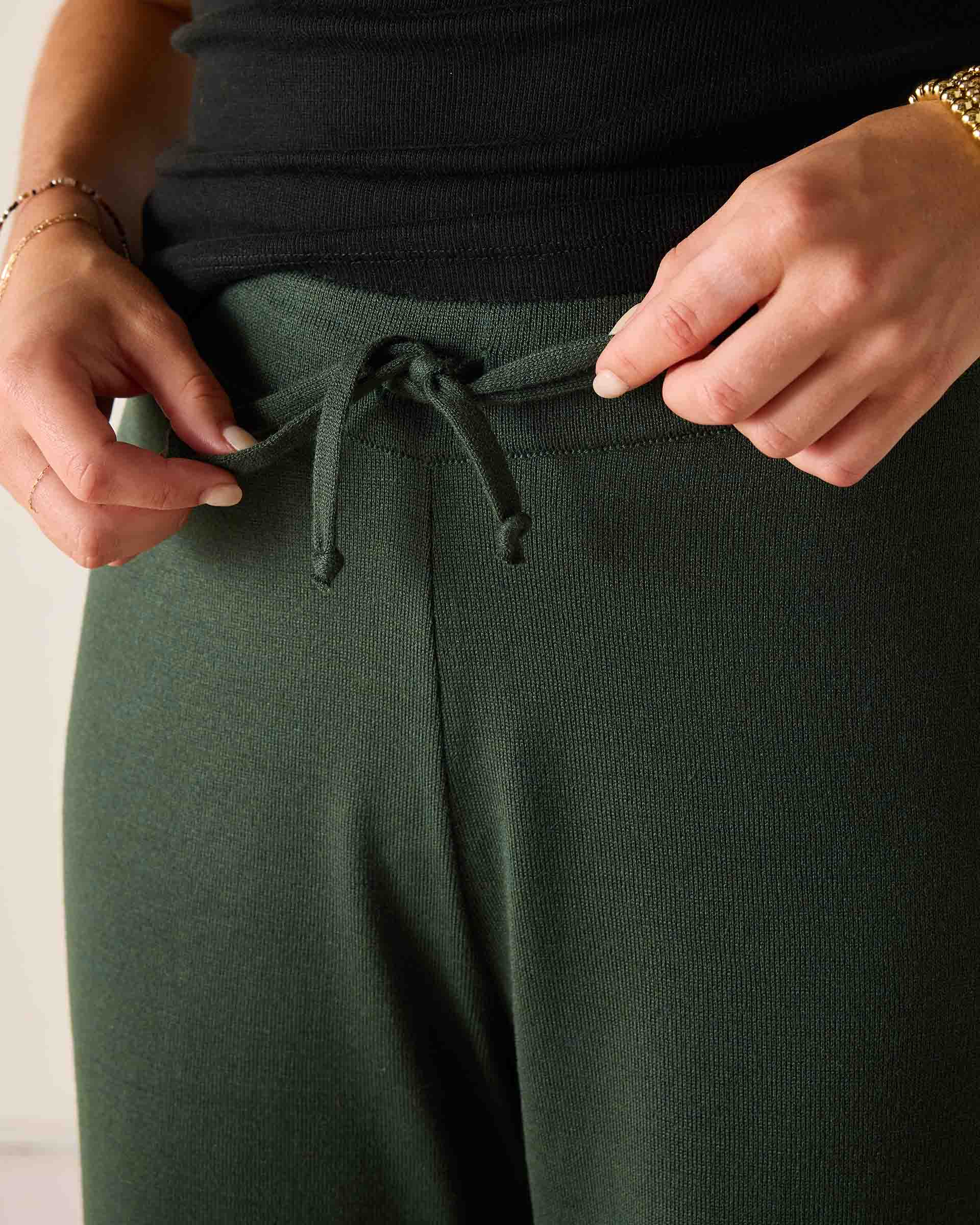 Deep emerald green knit fabric high-waisted pants with a drawstring waist.