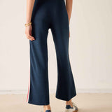 Navy knit wide-leg pants with a red and white stripe detail on the side.