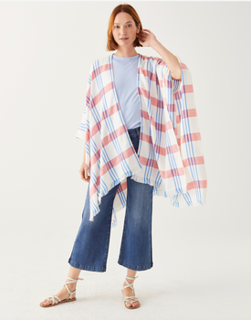female wearing white wrap with red and blue plaid and fringe on a white background