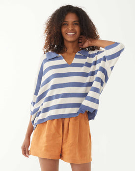 female wearing blue and white striped polo sweater on a white background