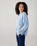 profile of woman showcasing mersea sol mate crewneck pullover in snowflake
