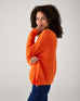 profile of woman showcasing mersea sol mate crewneck pullover in tangerine