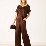 Chocolate brown silk-blend wide-leg pants with a relaxed fit and soft drape.